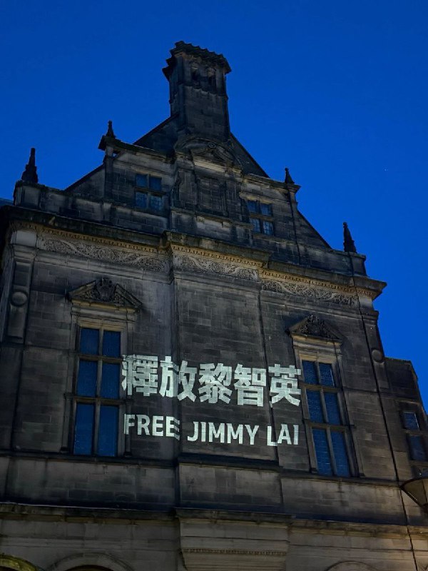1月11日，英国谢菲尔德市政厅外，市政厅墙面被民众投影出“释放黎智英”的标语和海报